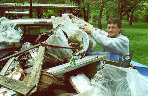 Scott Pachuta loading one more 
bunch of trash into the pickup truck from the Thornapple River 
Cleanup, May 20, 2000.