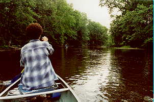 Kath 
paddling in the front of thornie's canoe.
